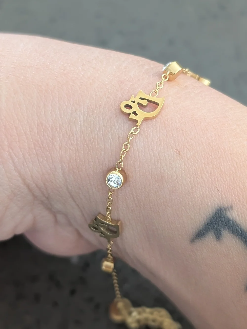 Gold-Tone Script Charm Bracelet with Clear Crystal Accents Stainless Steel